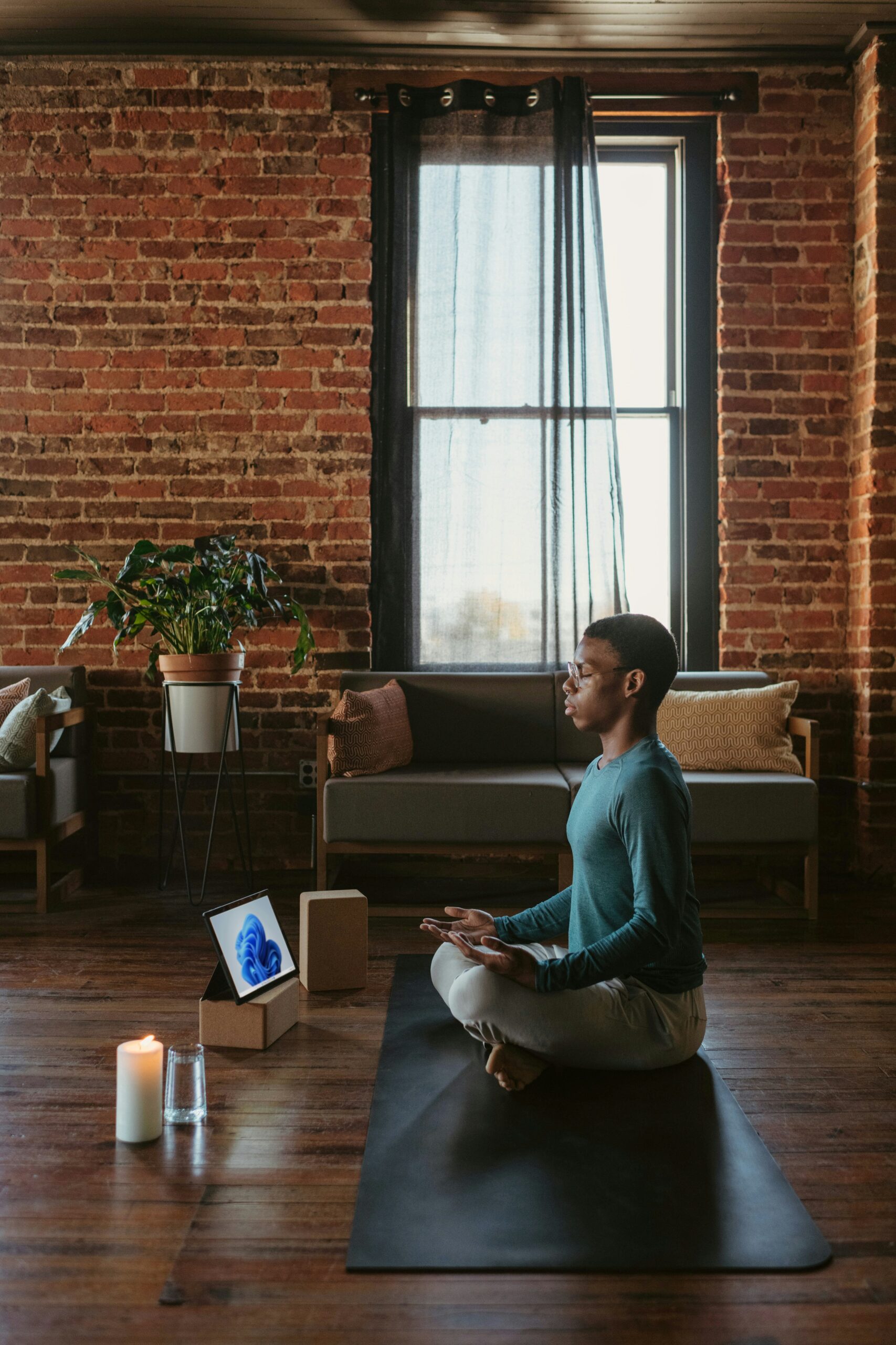 Black man practicing meditation as part of wellness at Refined Hue