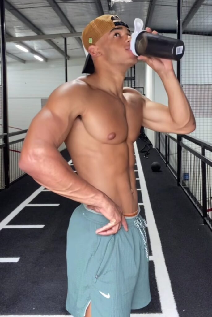 athlete hydrating after full-body workout